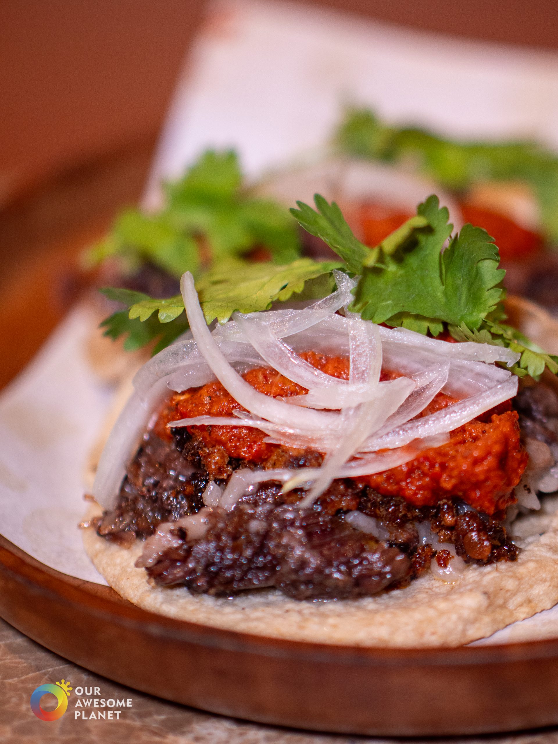 Campechano taco close-up showing wagyu beef, chorizo, and salsa tatemada