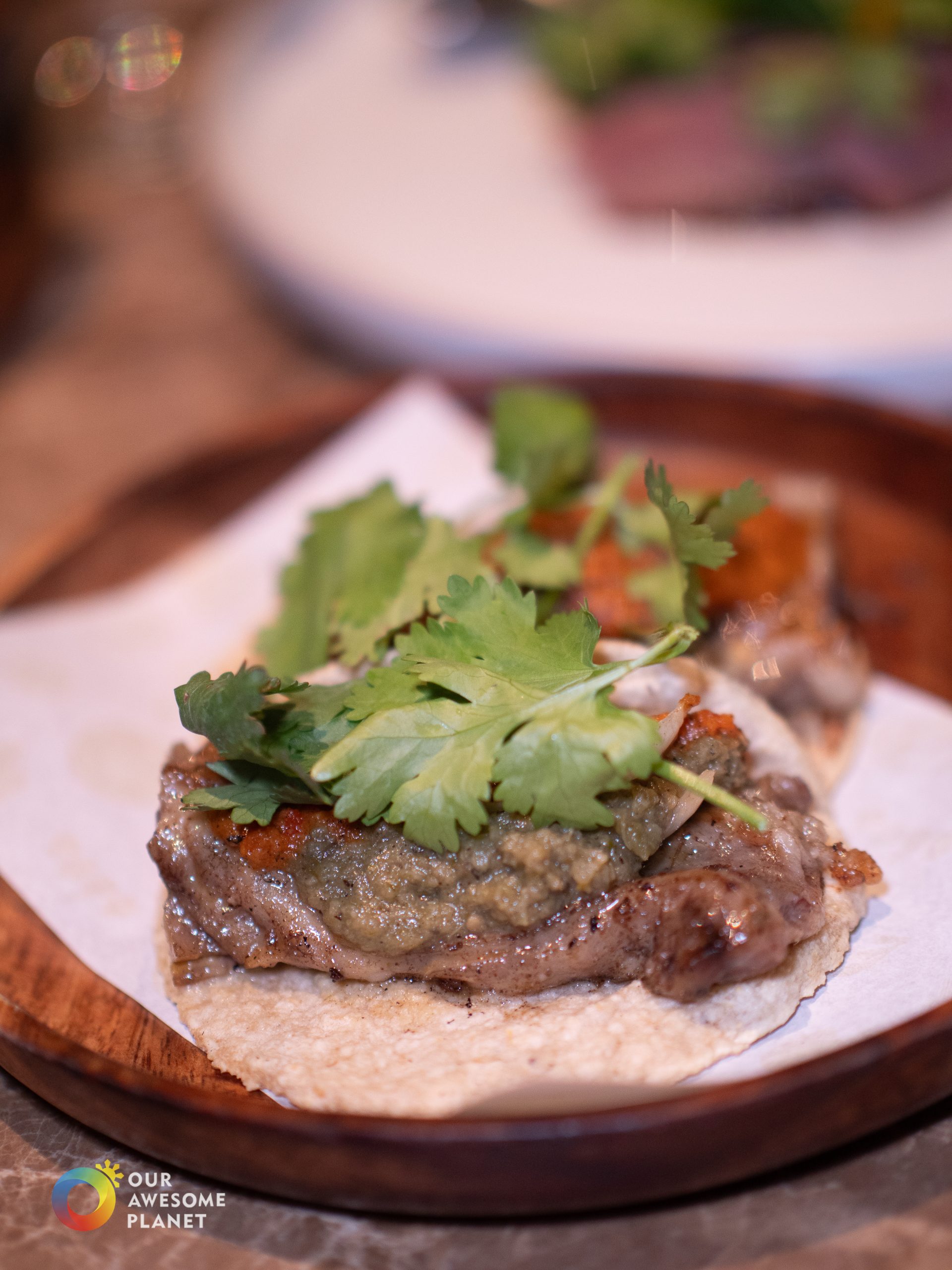 Lengua taco with salsa verde and cilantro on house-pressed tortilla